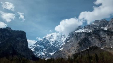 4k timelapse of moving clouds over snow-covered mountain tops