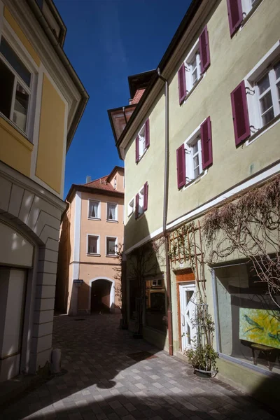 View in the old town of Ansbach. A narrow street with buildings painted in subtle colours. Bavaria Region Middle Franconia, Germany