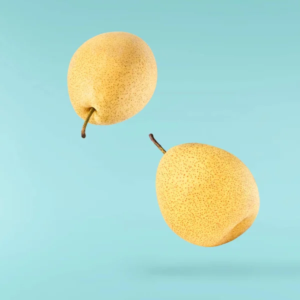 Fresh Yellow Ripe Raw Pear Falling Air Isolated Blue Background — Photo