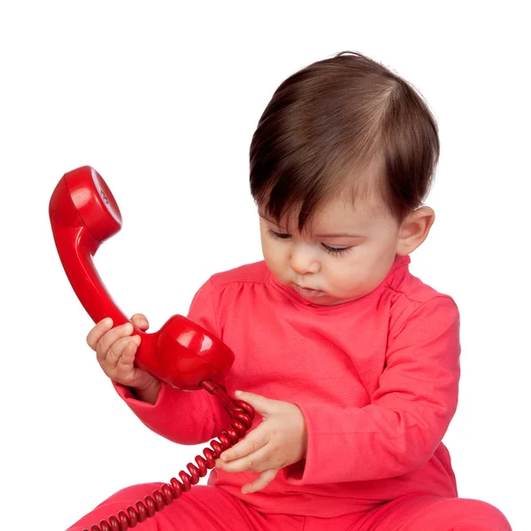 Adorável menina com um telefone vermelho — Fotografia de Stock