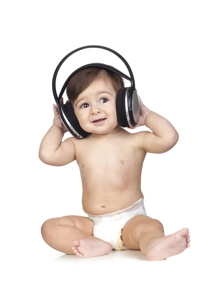 Bébé drôle en couches écoutant de la musique — Photo