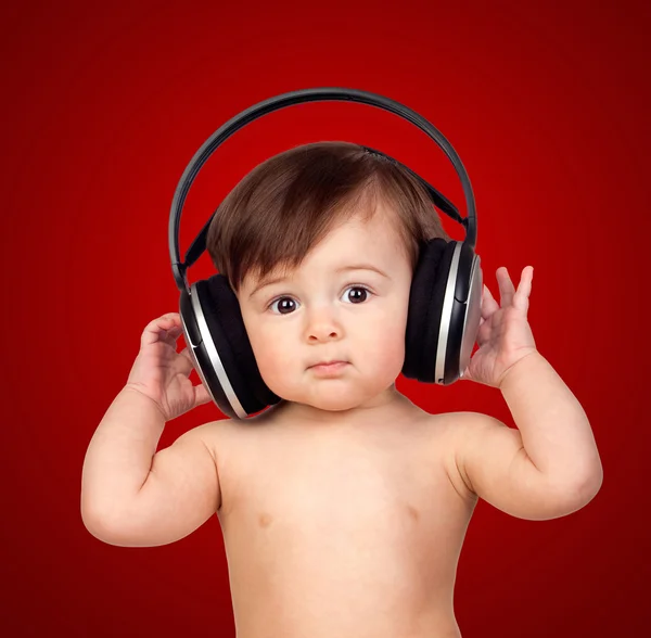 Adorable baby girl with big headphones — Stock Photo, Image