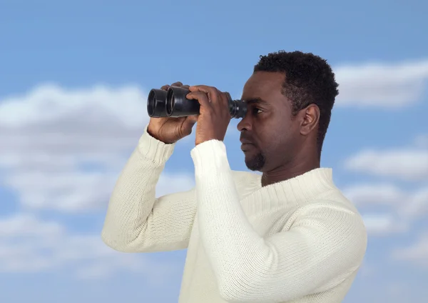 Attractive african man looking through binoculars — Stock Photo, Image