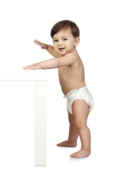 Schattige baby naast een tabel — Stockfoto