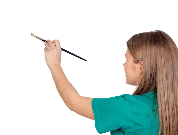 Menina adolescente pintando algo com um pincel — Fotografia de Stock