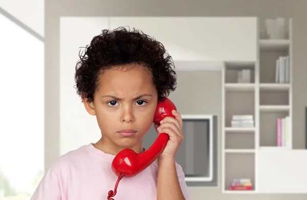 Angry latin with red phone — Stock Photo, Image