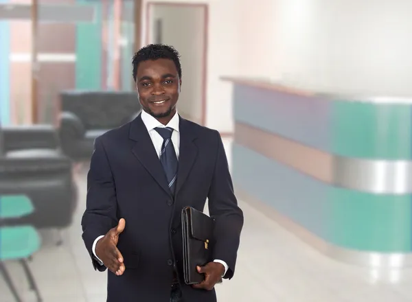 Happy businessman extending his hand for greeting — Stock Photo, Image