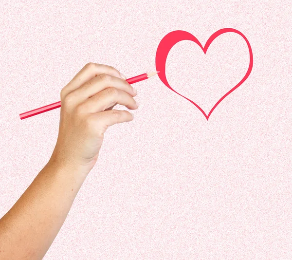 Hand with red pencil painting a heart — Stock Photo, Image