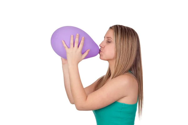 Attractive blond girl swelling a purple balloon — Stock Photo, Image