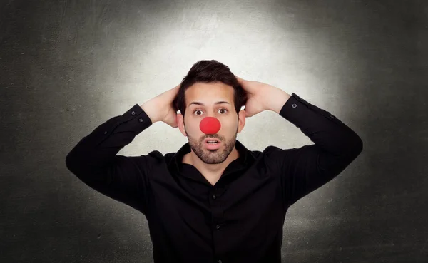 Astonished businessman with clown nose — Stock Photo, Image