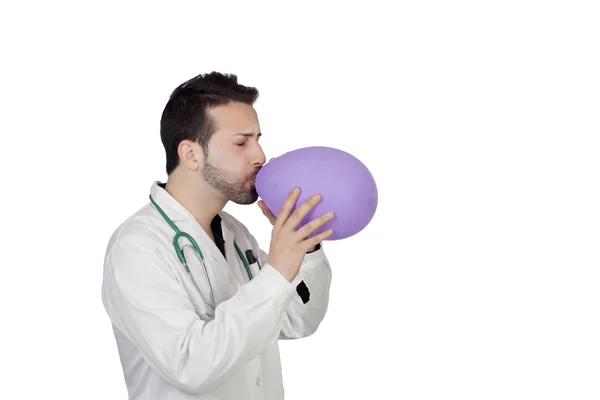 Young Male Doctor Blowing Balloon — Stock Photo, Image