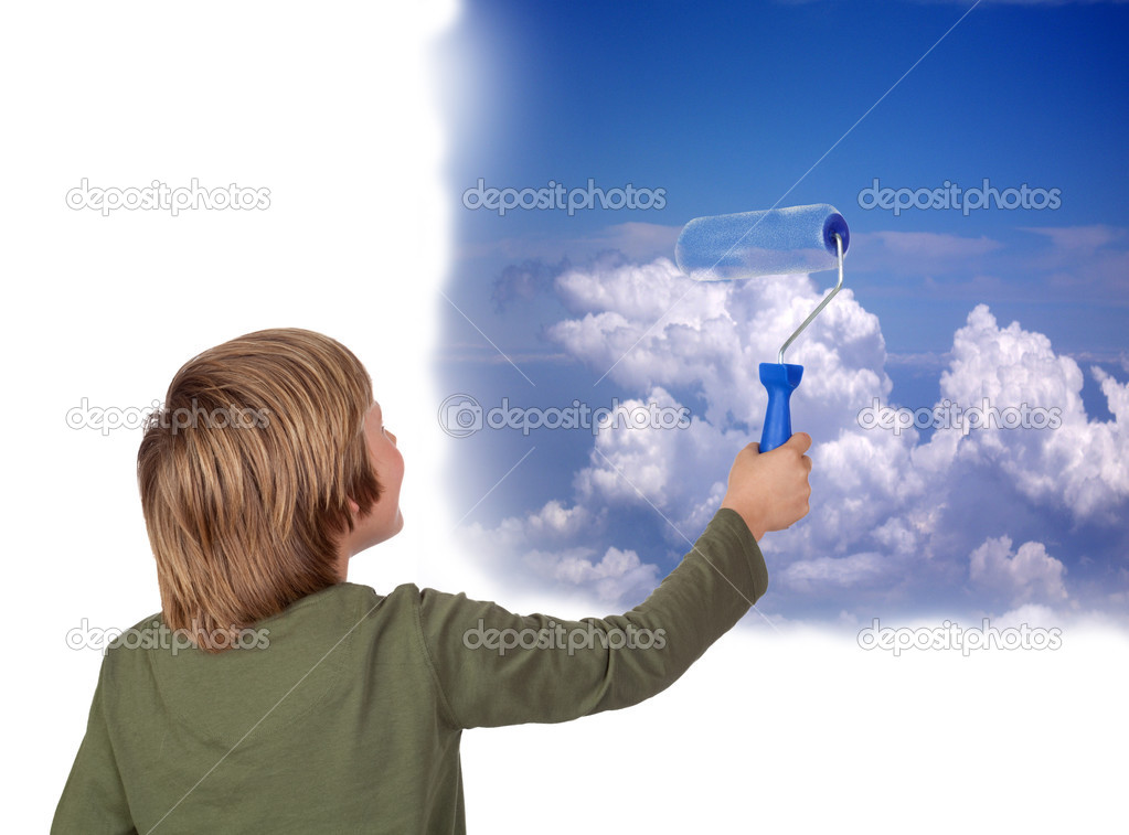 Adorable child painting a beautiful sky with a roller