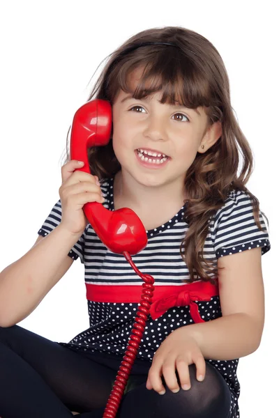Entzückendes kleines Mädchen mit rotem Telefon — Stockfoto