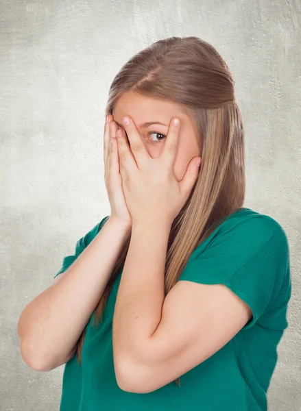 Beautiful shy girl with green t-shirt covering her face — Stock Photo, Image