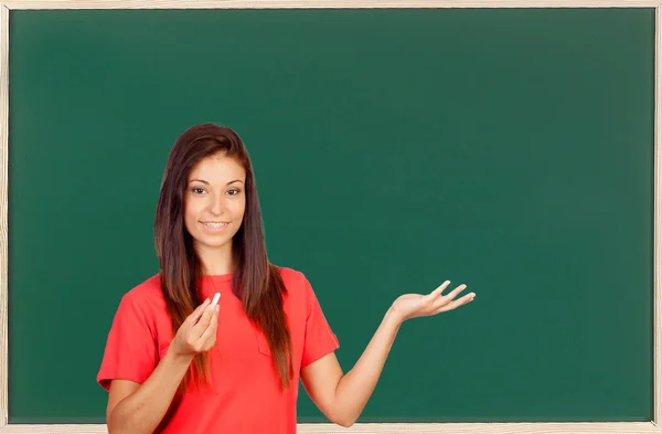 Attractive brunette teacher with a chalk — Stock Photo, Image