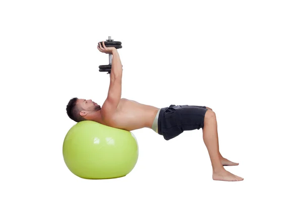 Strong man practicing exercises with dumbbells sit on a ball — Stock Photo, Image