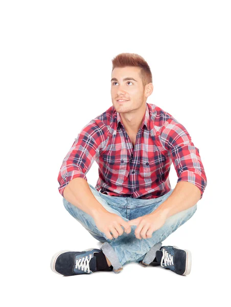 Pensive casual boy sitting on the floor — Stock Photo, Image