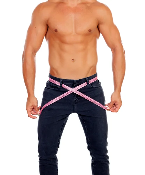 Men with perfect abs measuring his waist — Stock Photo, Image