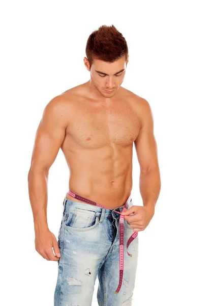 Men with perfect abs measuring his waist — Stock Photo, Image