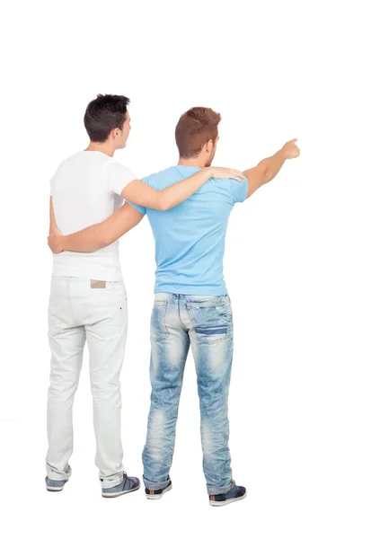 Couple of best friends pointing something Stock Picture