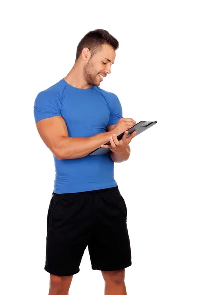 Handsome personal trainer with a clipboard — 图库照片