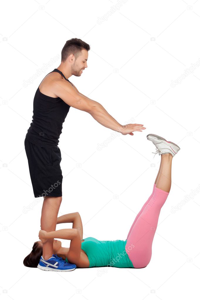 handsome personal trainer helping a girl in her training