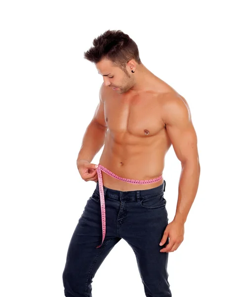 Men with perfect abs measuring his waist — Stock Photo, Image