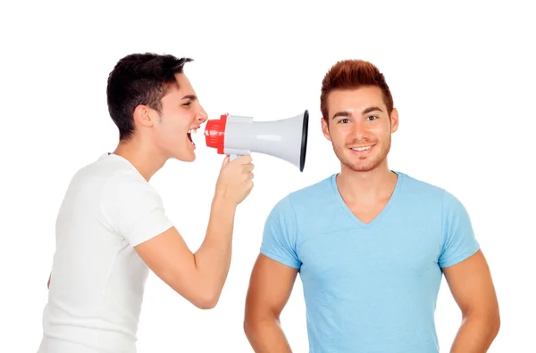 Young men screams to his friend through a megaphone — Stock Photo, Image