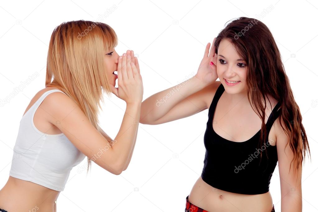 Two teen sisters whispering
