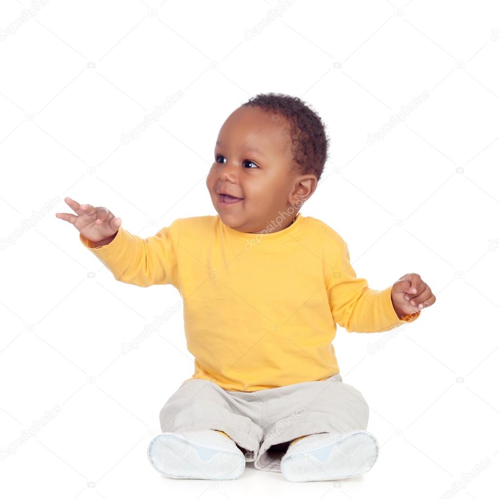 Adorable african baby sitting on the floor