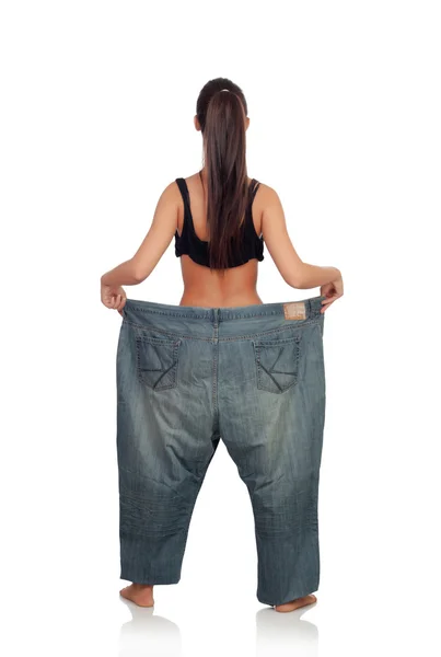 Mulher magro de volta com calças enormes — Fotografia de Stock