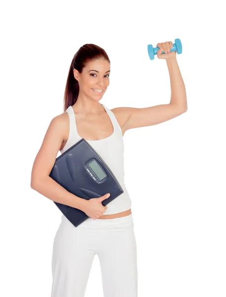 Happy girl in white toning her muscles and with a scale — Stock Photo, Image