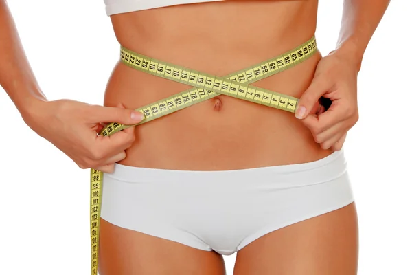 Chica en ropa interior blanca con una cinta métrica alrededor de su cintura —  Fotos de Stock