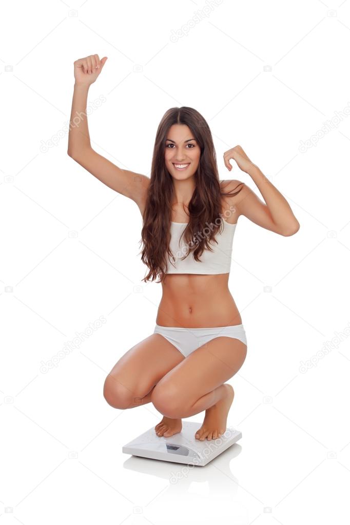 Happy woman celebrating her new weight on a scale