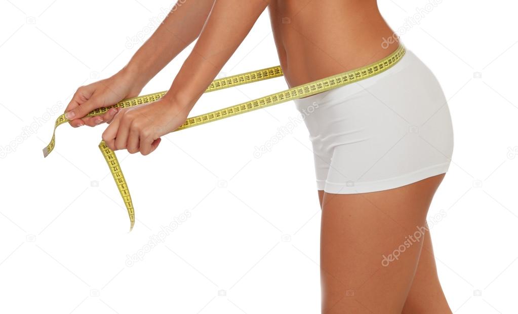 Woman Body with a Tape Measure Measuring Her Waist Stock Photo