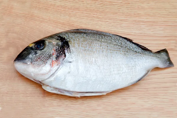 Healthy fresh fish on wooden board — Stock Photo, Image