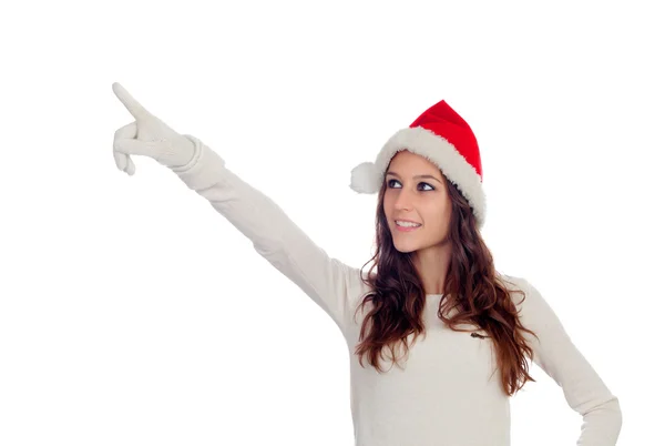 Attraente ragazza casual con cappello di Natale che punta qualcosa — Foto Stock