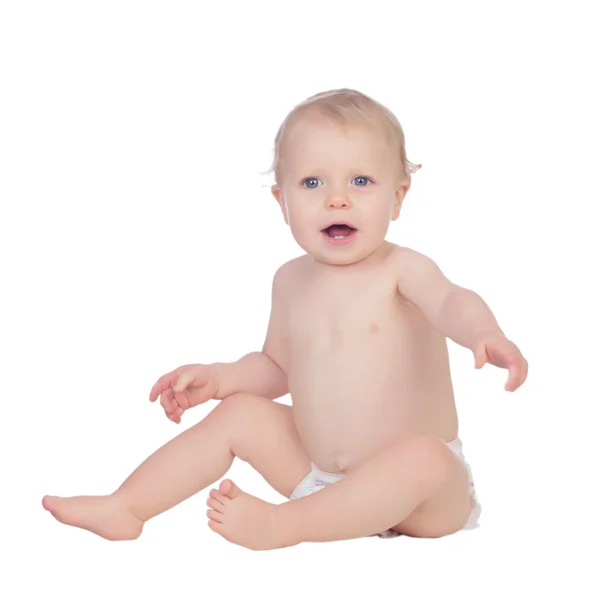 Adorable blonde baby in diaper sitting on the floor — Stock Photo, Image