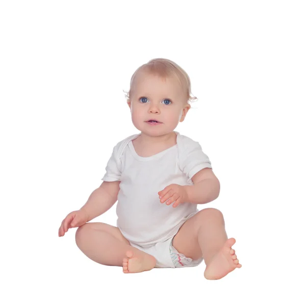 Adorable blonde baby sitting on the floor Stock Picture