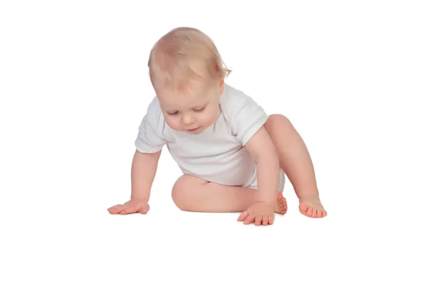 Entzückendes blondes Baby auf dem Boden sitzend Stockbild