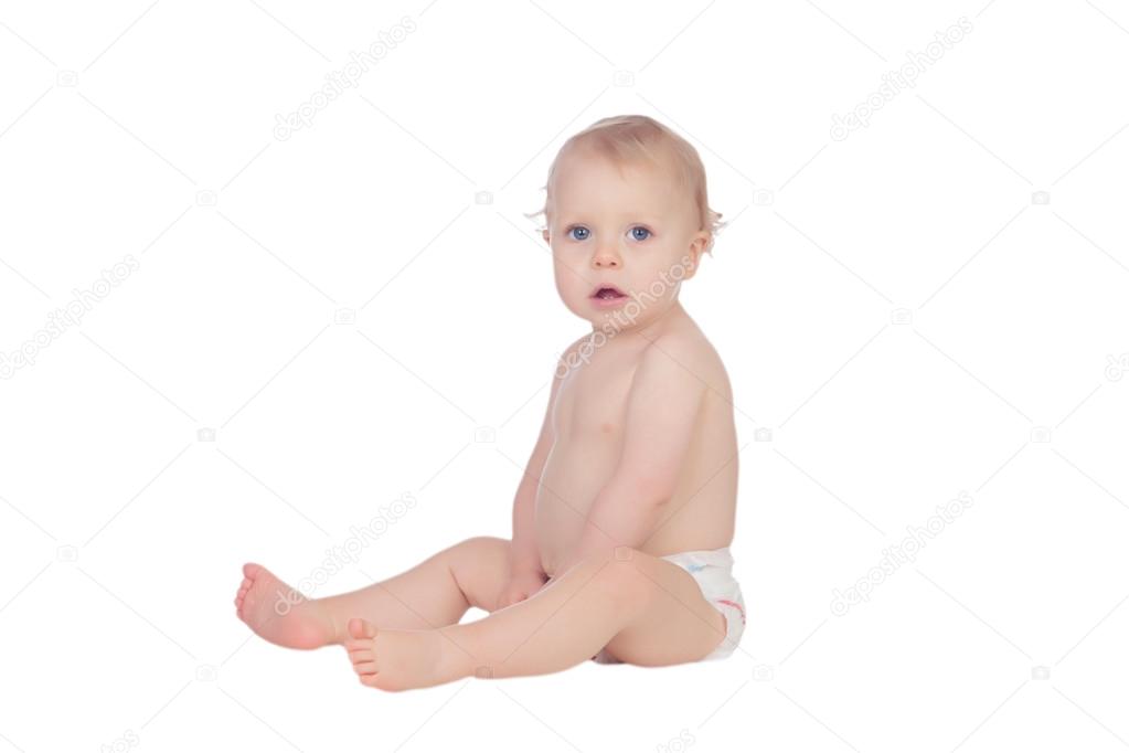 Adorable blonde baby in diaper sitting on the floor