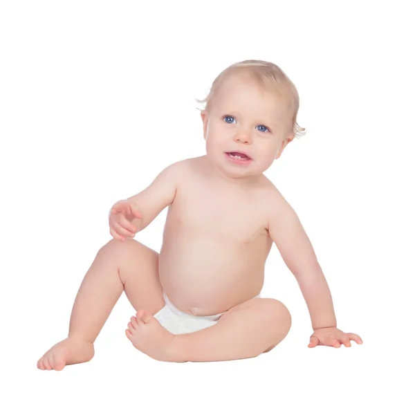 Adorable blonde baby in diaper sitting on the floor — Stock Photo, Image