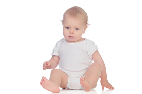 Adorable blonde baby sitting on the floor — Stock Photo, Image