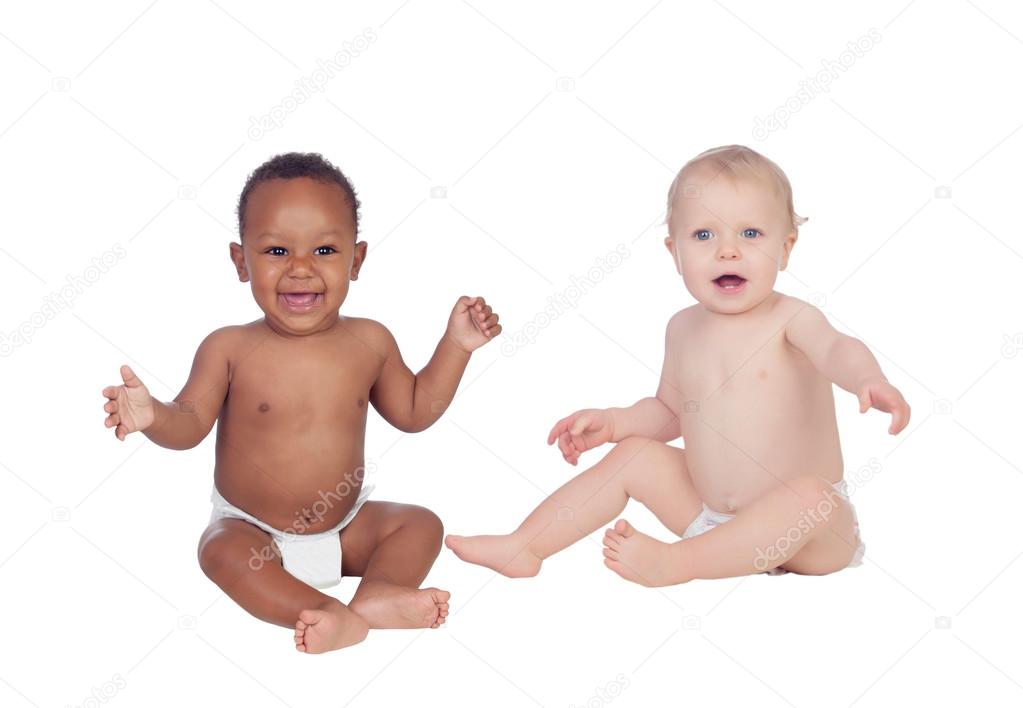 Couple of Babies African and Caucasian in diaper sitting