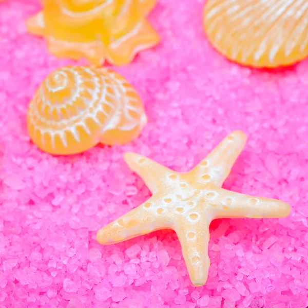 Yellow soaps on pink bath salts — Stock Photo, Image