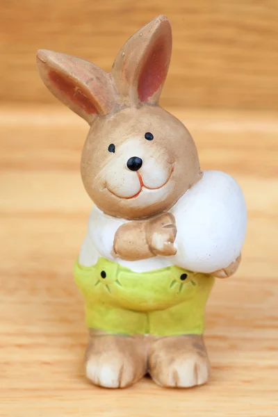Easter time. Ceramic rabbit with a egg — Stock Photo, Image