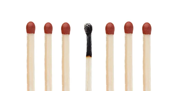 Many matches without burning and a burned match — Stock Photo, Image