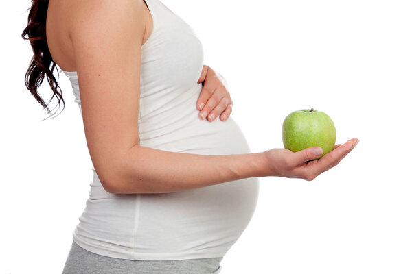 Beatiful pregnant woman with a apple