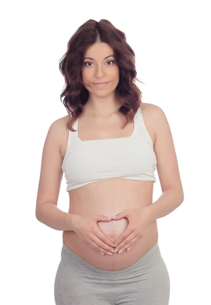 Беременная женщина формирует сердце на животе — стоковое фото