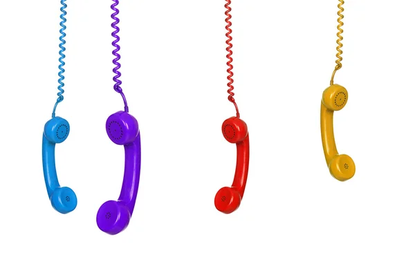 Quattro telefoni colorati appesi — Foto Stock